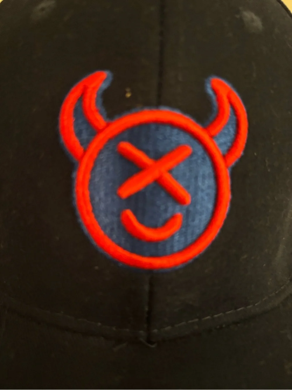 Source Unknown Black Cap with Red & Blue Devil Emblem